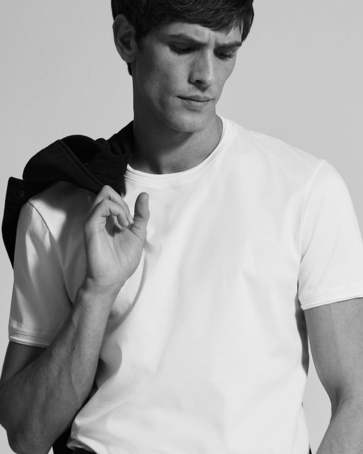 Man in slim fit white cotton t-shirt with small ribbed cuff detail